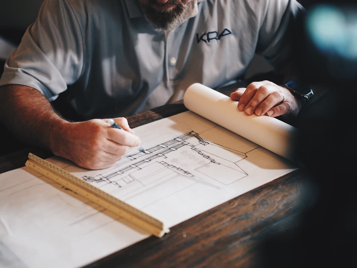 A contractor reviewing project plans on a workbench